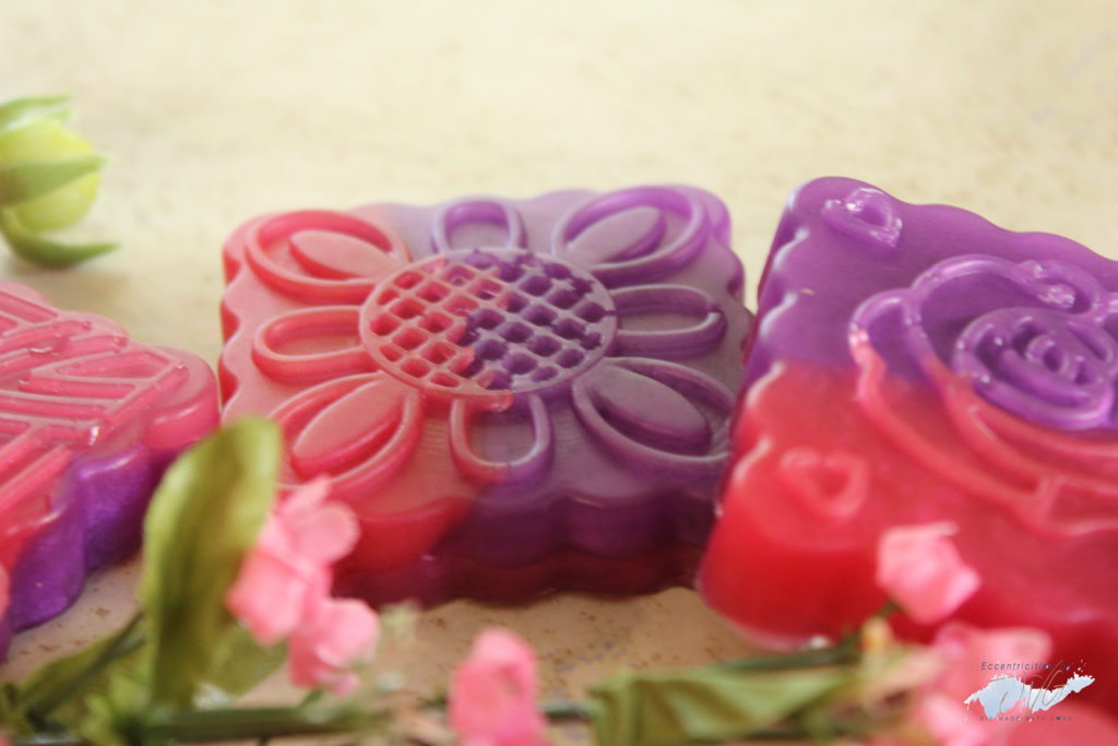 Floral handmade hand soap final products in purple and pink close up